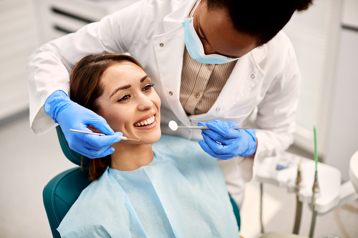 A specialist dentist examining a patient's teeth