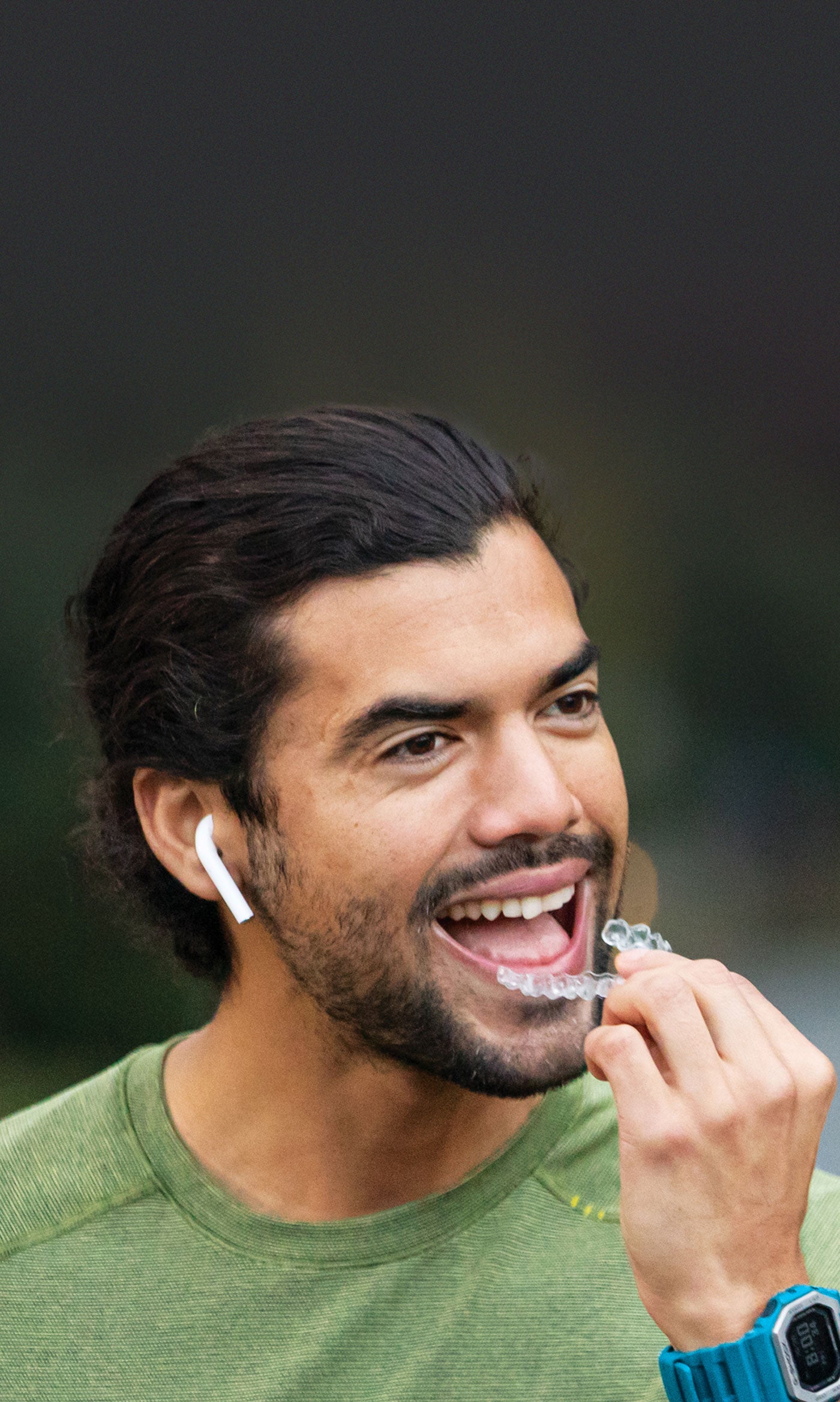 Man holding an Invisalign aligner