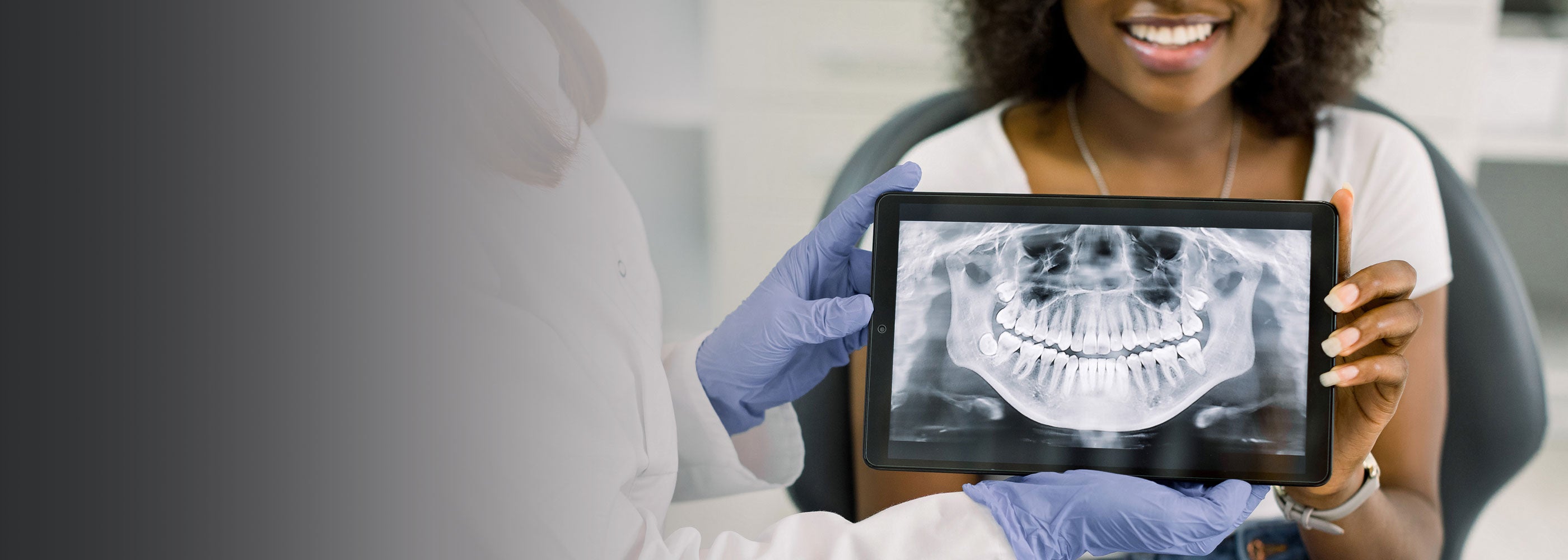 Patient having dental examination looking at dental x-ray